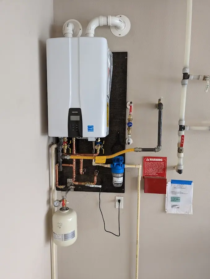 Professional plumber installing copper piping in a Lehman home